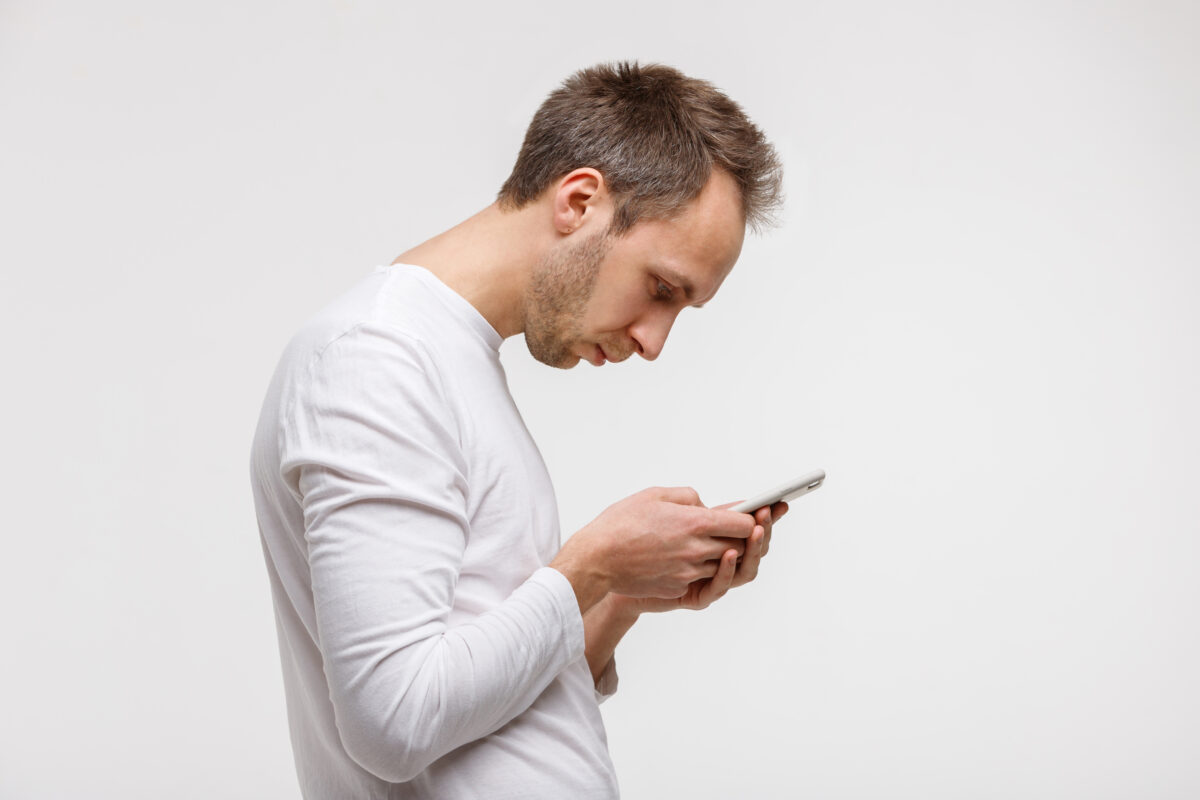 man looking and using smart phone with scoliosis, Incorrect posture
